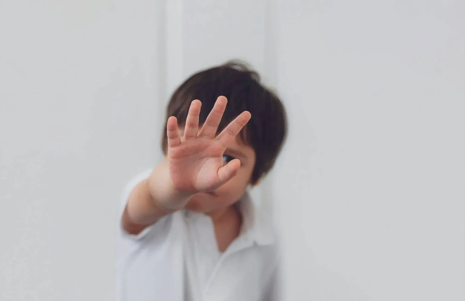 bigstock-Blurry-Face-Of-Boy-Showing-Han-413990789-min-1536x994.webp