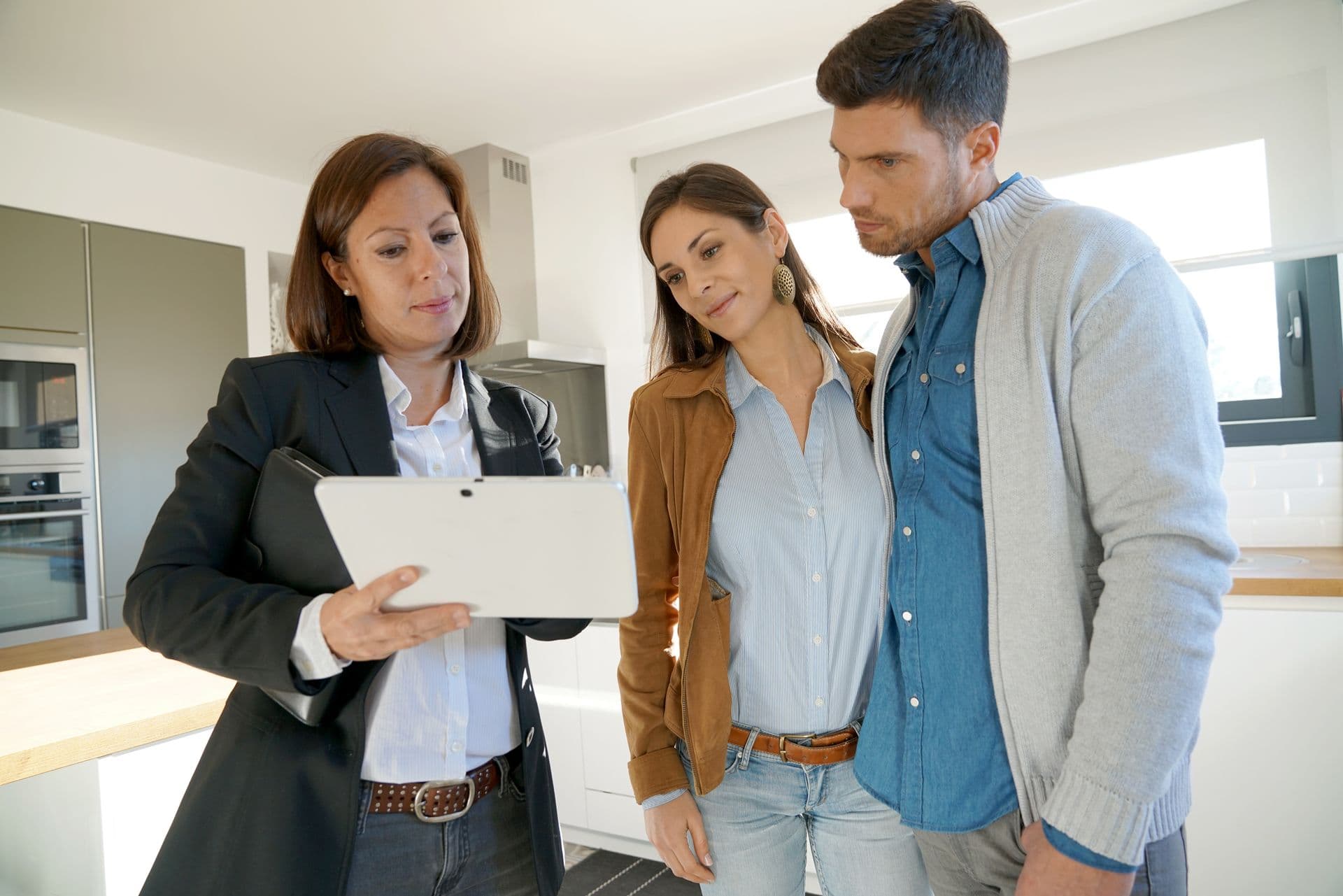 bigstock-Couple-with-real-estate-agent--161235986.jpg