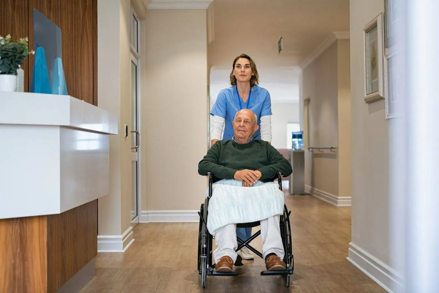 bigstock-Nurse-helping-old-man-in-wheel-429391607-min-1536x1024.webp