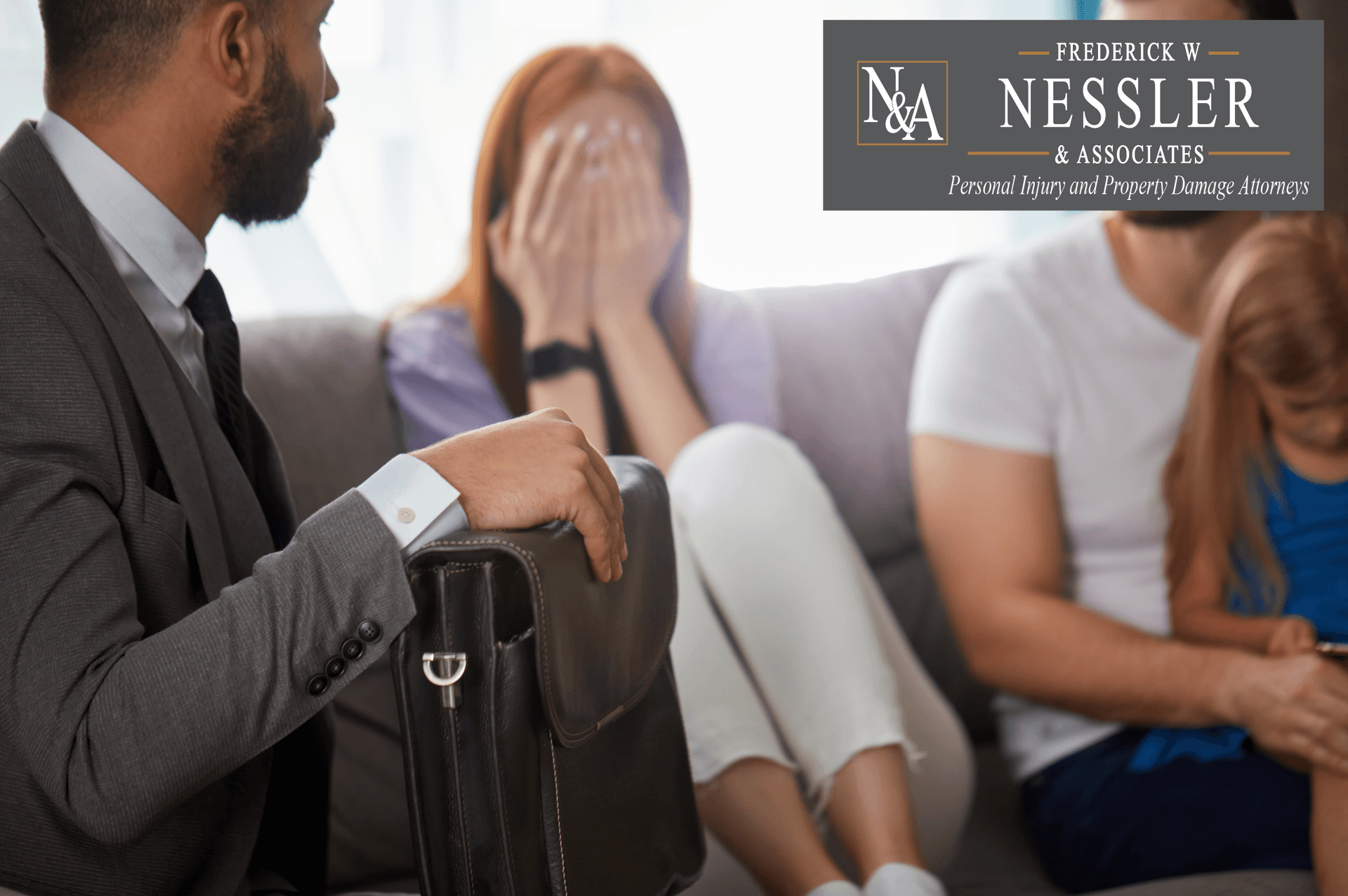 Attorney meeting with injured family during personal injury consultation. Nessler and Associates